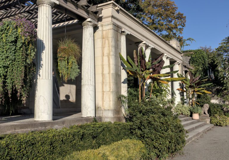 hanging plants between roman style columns