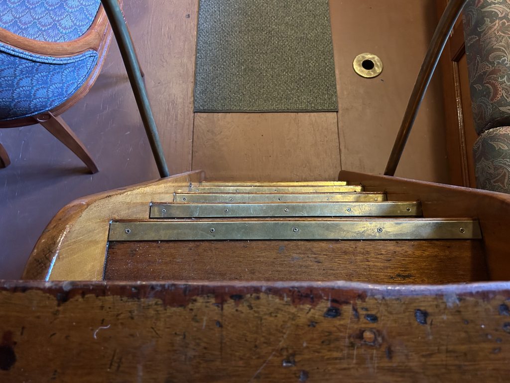 Steep, narrow staircase descending on the Wanda III in Gravenhurst Muskoka