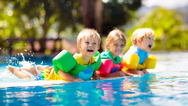 Three children with life jackets on