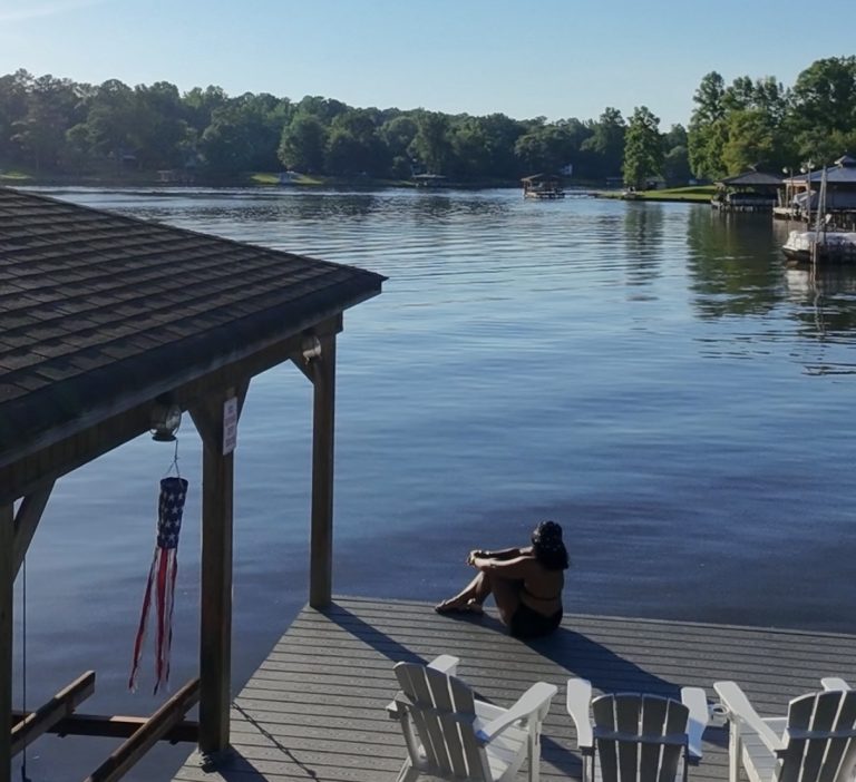 woman sitting on dock at Georgia lake